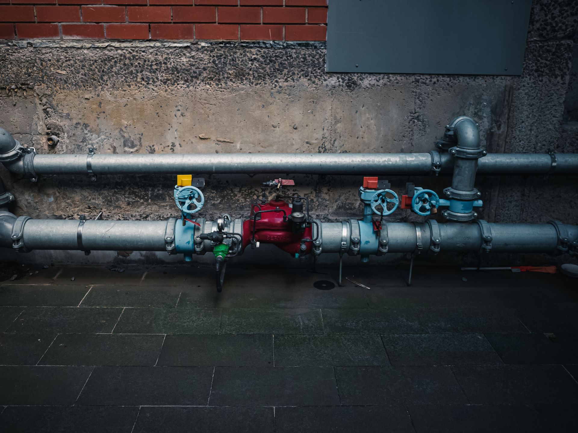 Industrial pipes and valves on a factory wall