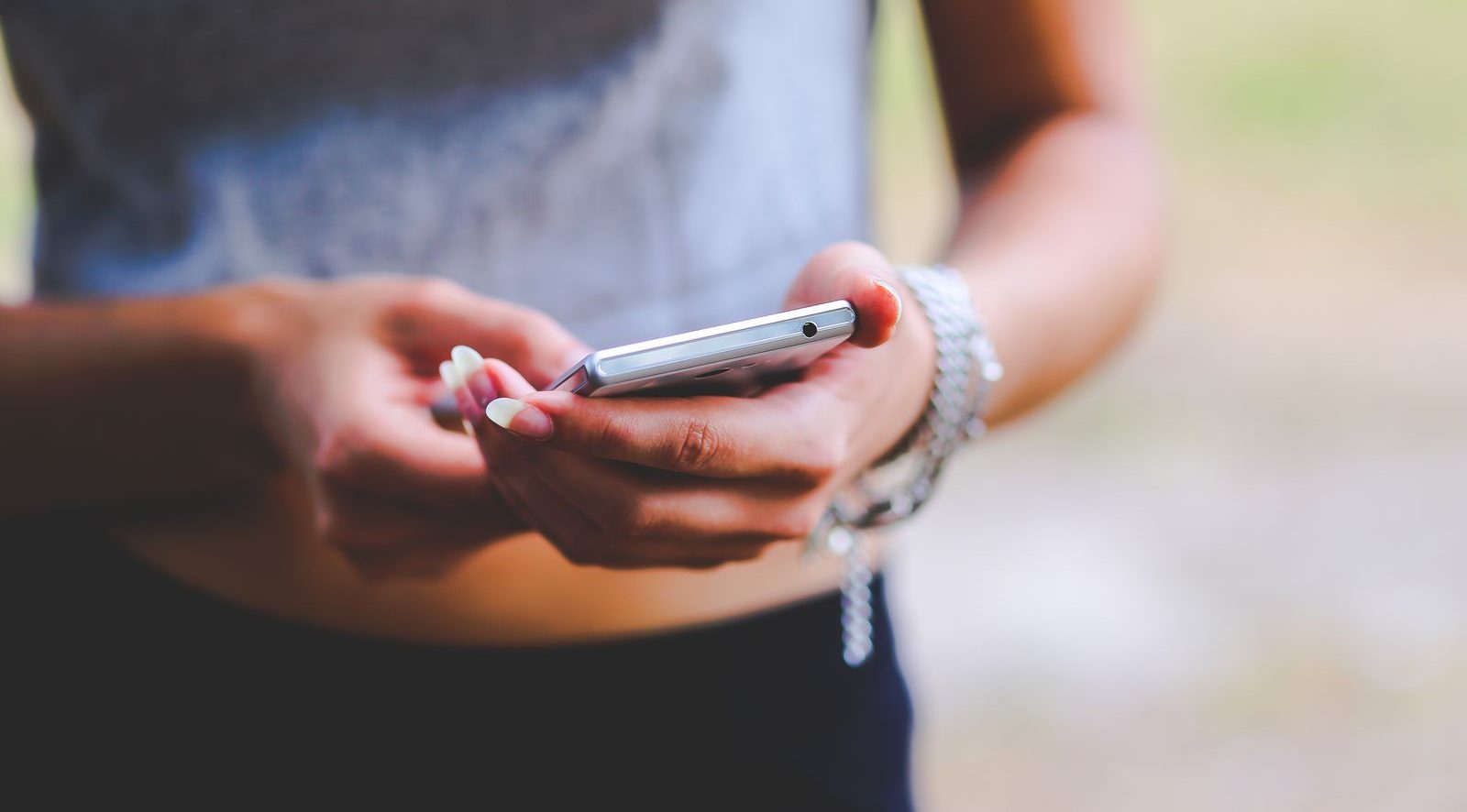 Close-up of hands texting on a phone